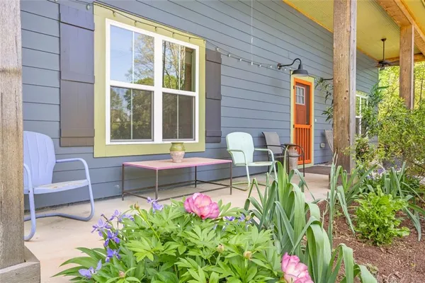 a front view of a house with outdoor seating