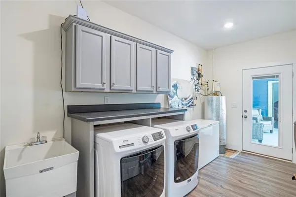 a kitchen with stainless steel appliances granite countertop a refrigerator a stove a sink and a microwave