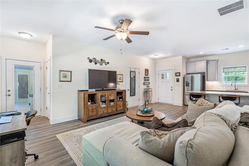 225 Hamrick Road Bremen, GA 30110 - Photo 36 of 61 a living room with furniture a flat screen tv and kitchen view