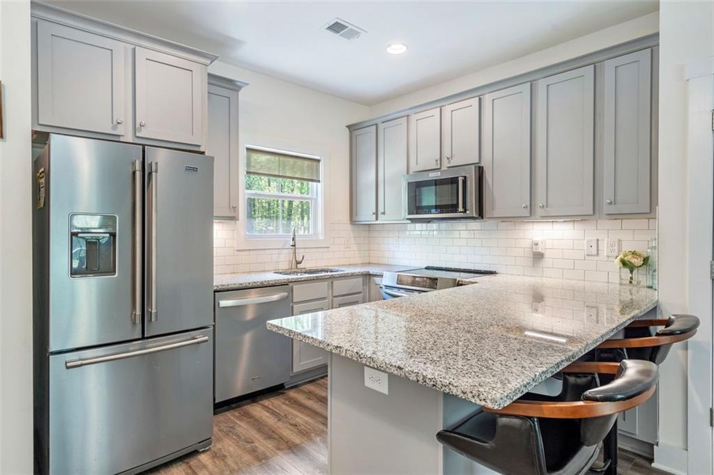 225 Hamrick Road Bremen, GA 30110 - Photo 37 of 61 a kitchen with stainless steel appliances granite countertop a refrigerator a stove a sink and a microwave