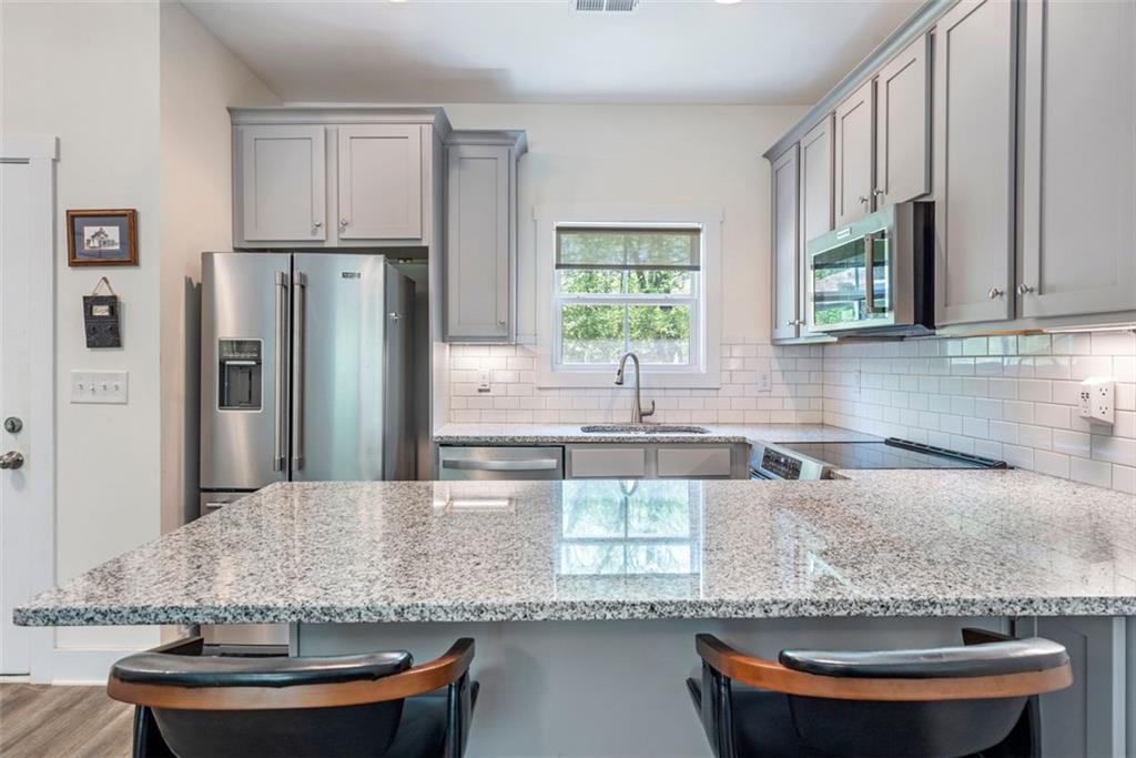 225 Hamrick Road Bremen, GA 30110 - Photo 38 of 61 a kitchen with stainless steel appliances granite countertop a sink a window and a counter space