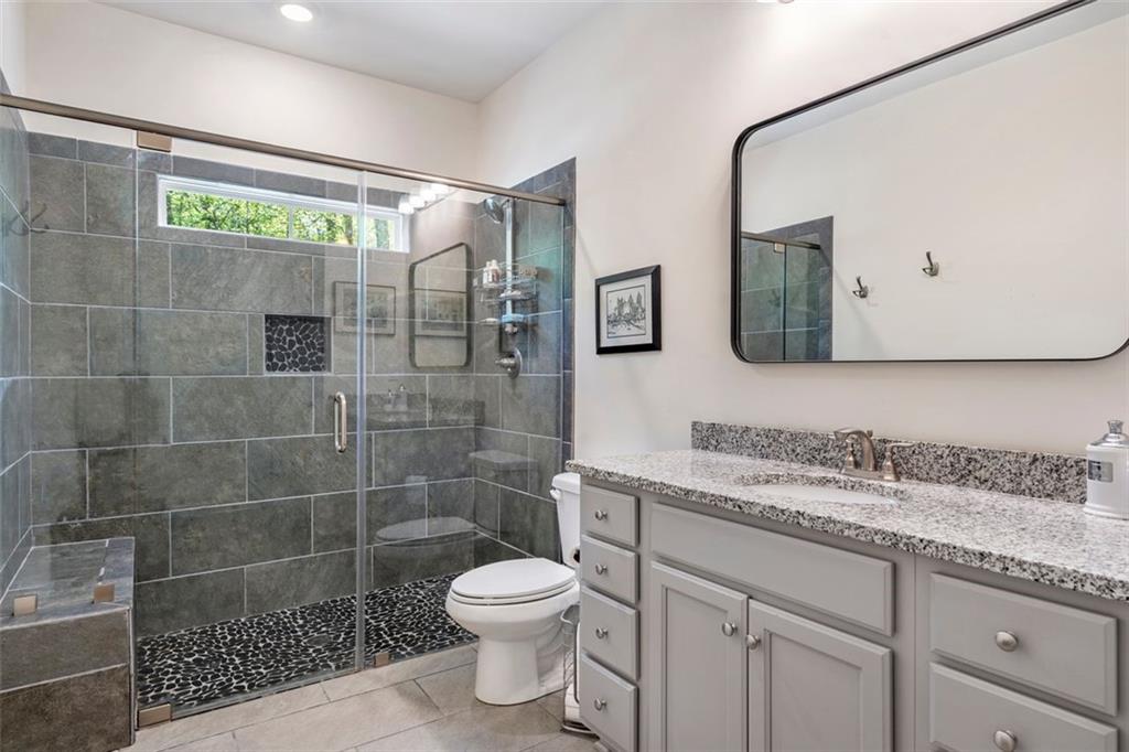 225 Hamrick Road Bremen, GA 30110 - Photo 40 of 61 a bathroom with a granite countertop sink a toilet and a shower