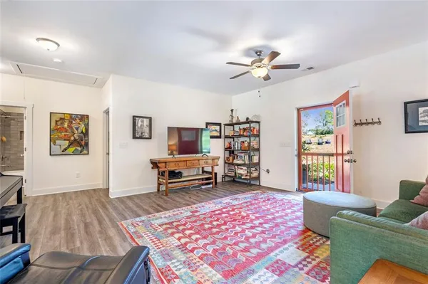a kitchen with granite countertop stainless steel appliances a refrigerator microwave and wooden floor