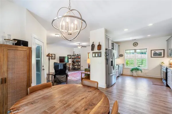 a kitchen with stainless steel appliances granite countertop a sink and a refrigerator