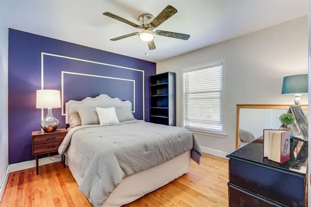 a spacious bedroom with a bed and a window