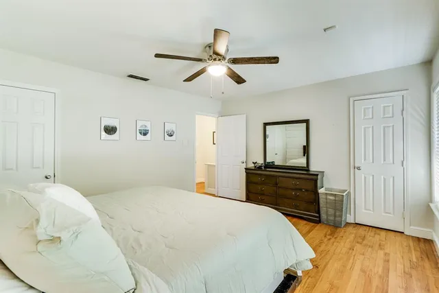 a bedroom with a bed and wooden floor