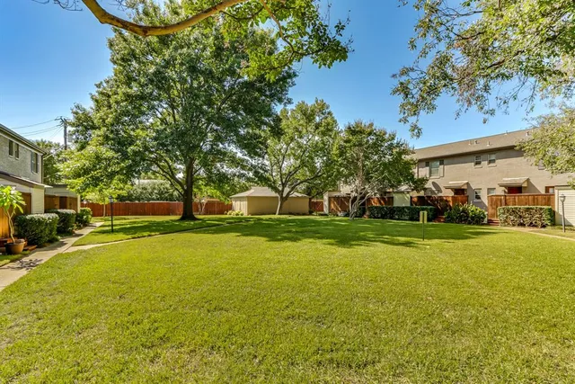 a view of a swimming pool and trees in the background