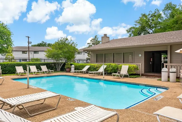a view of a house with swimming pool and sitting area