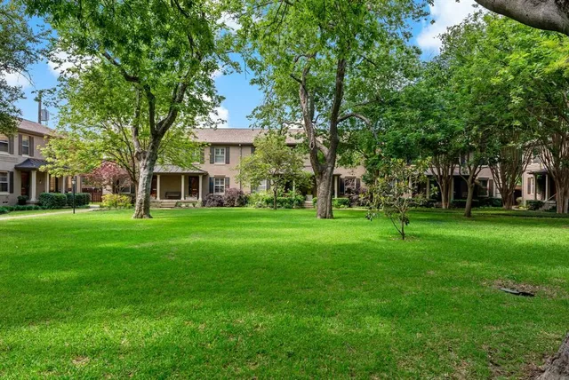 front view of a brick house with a yard