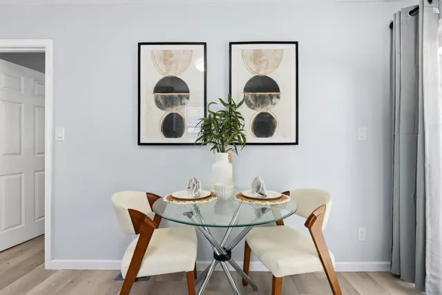 a dining room with furniture and wooden floor