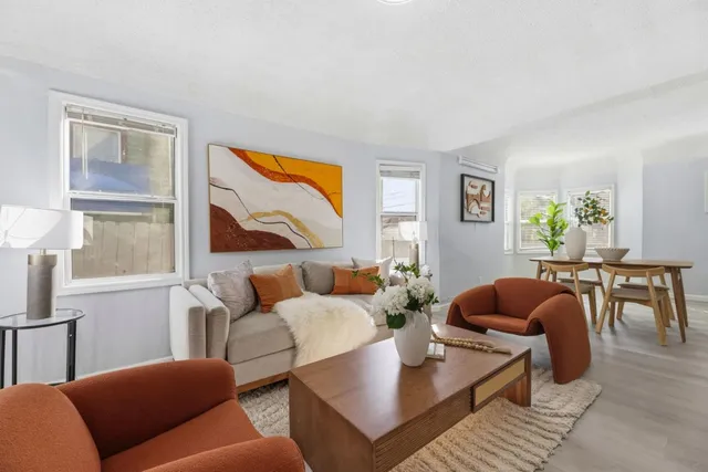 a living room with furniture and a potted plant
