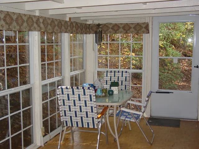 a view of a room with chairs and windows