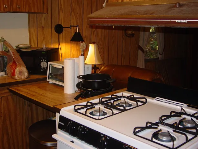 a stove top oven sitting inside of a kitchen