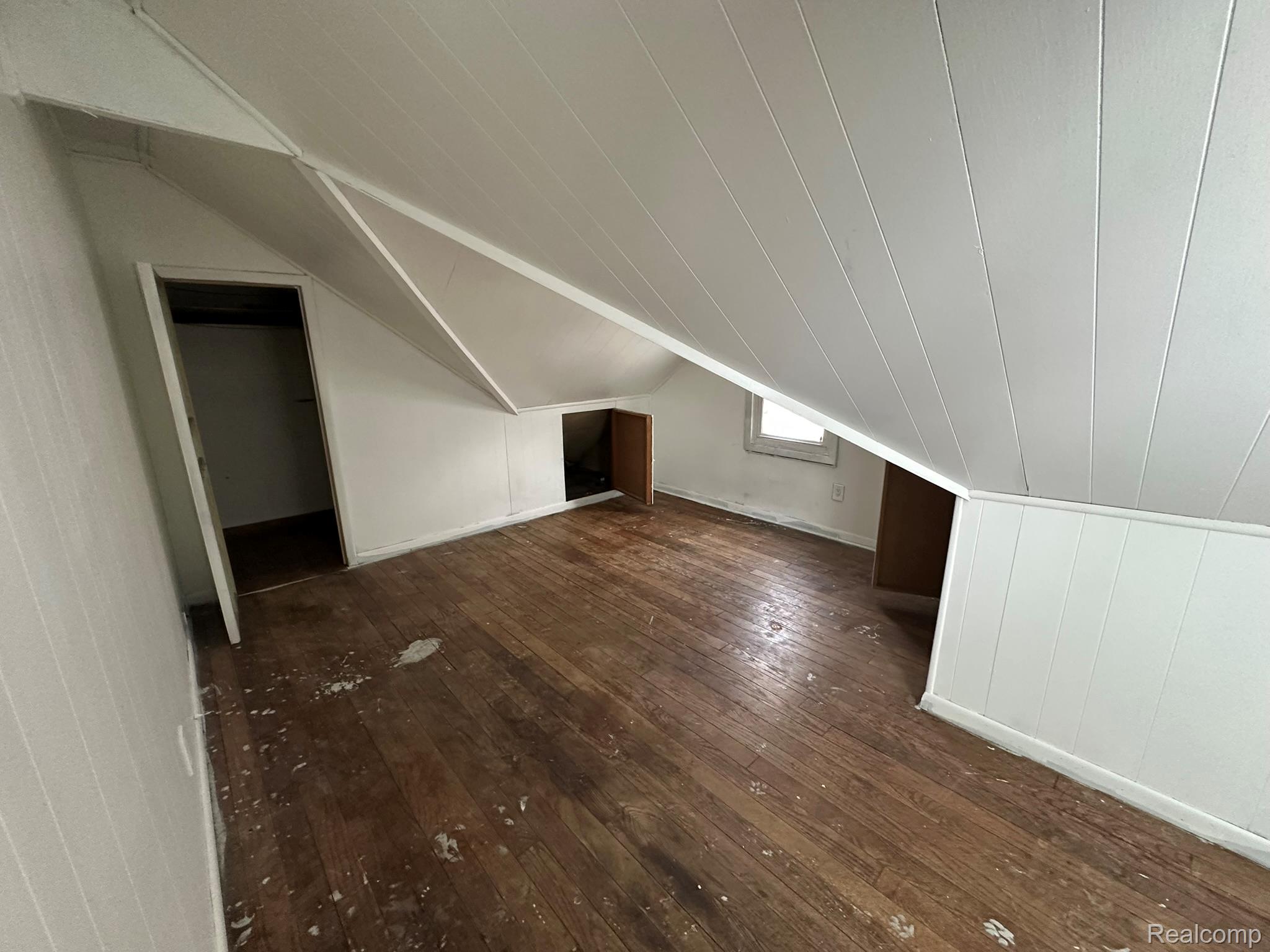 15759 Evergreen Road Detroit, MI 48223 - Photo 21 of 25 Bonus room featuring dark wood-style floors and vaulted ceiling