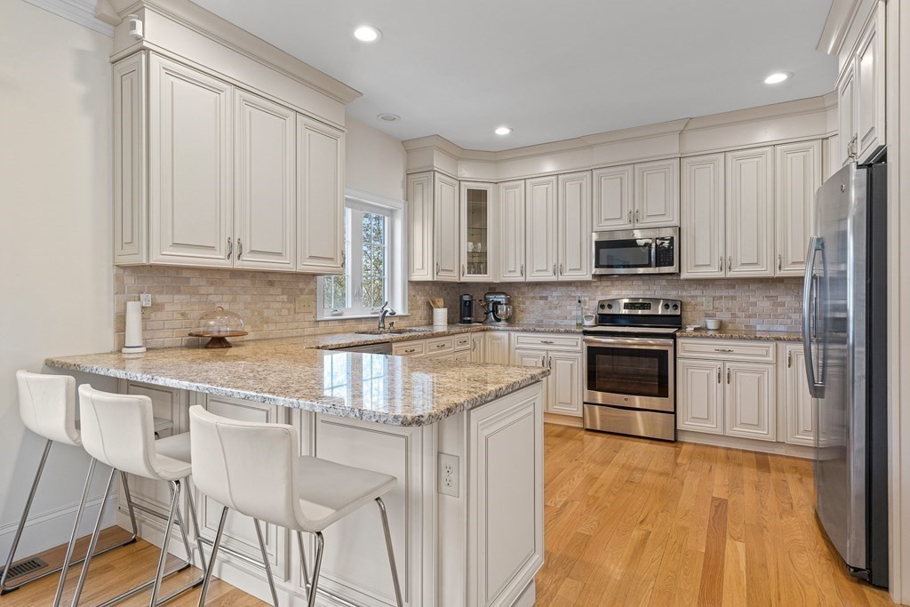 5 Fairview Road Framingham, MA 01702 - Photo 2 of 36 a kitchen with kitchen island granite countertop wooden cabinets and stainless steel appliances
