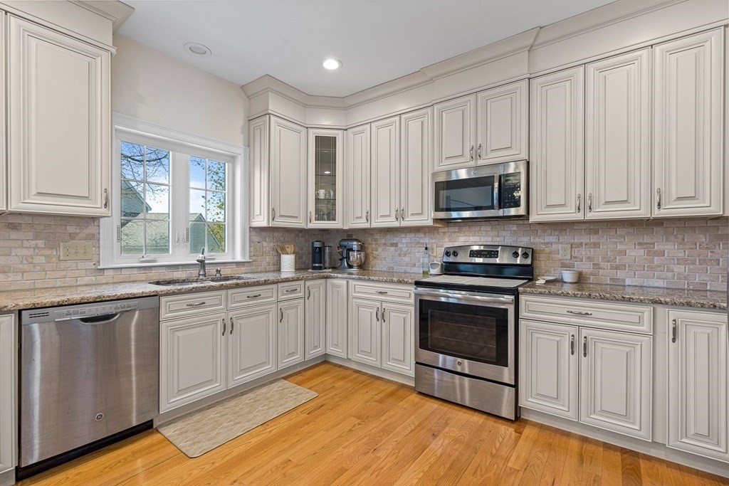 5 Fairview Road Framingham, MA 01702 - Photo 3 of 36 a kitchen with stainless steel appliances granite countertop a stove a sink and a microwave