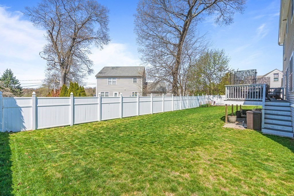 5 Fairview Road Framingham, MA 01702 - Photo 34 of 36 a view of backyard with table and chairs and wooden fence