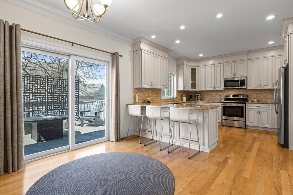 5 Fairview Road Framingham, MA 01702 - Photo 7 of 36 a kitchen with stainless steel appliances granite countertop a stove top oven a sink dishwasher a refrigerator and white cabinets with wooden floor
