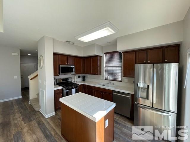2115 Stanhope Lane Reno, NV 89502 - Photo 4 of 15 a kitchen with a refrigerator a sink and a stove top oven