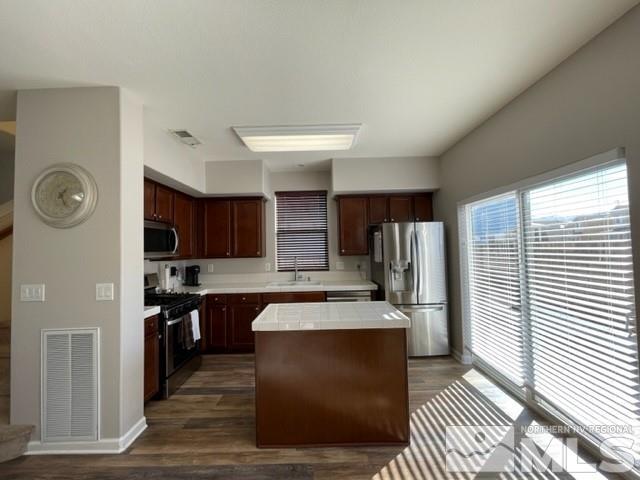 2115 Stanhope Lane Reno, NV 89502 - Photo 5 of 15 a large kitchen with stainless steel appliances kitchen island granite countertop a refrigerator and a stove top oven