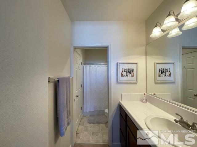2115 Stanhope Lane Reno, NV 89502 - Photo 9 of 15 a bathroom with a sink and a mirror