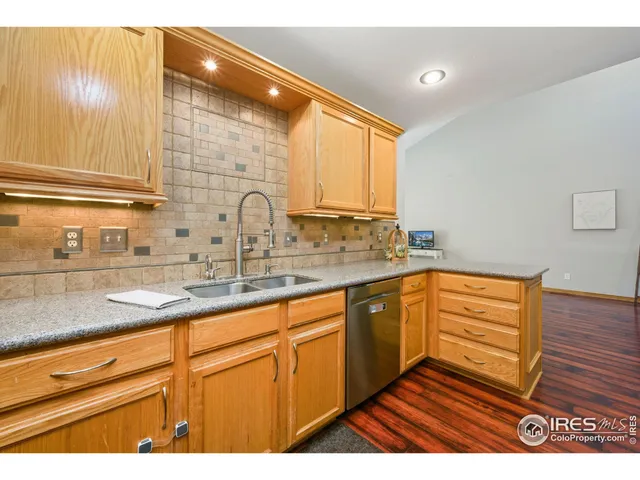 a kitchen with stainless steel appliances granite countertop a sink and cabinets