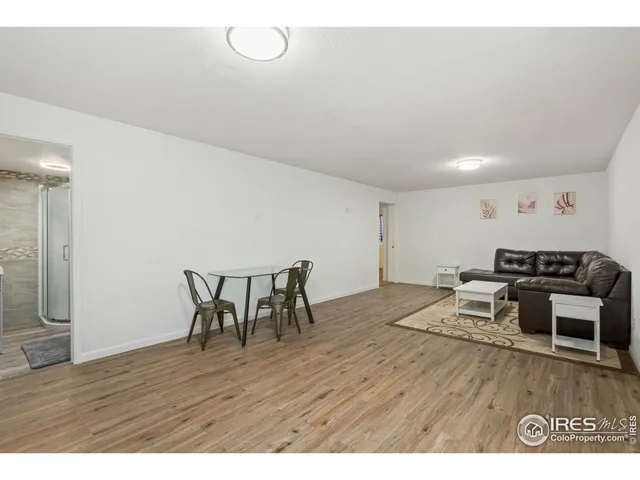 a living room with furniture wooden floor and a table