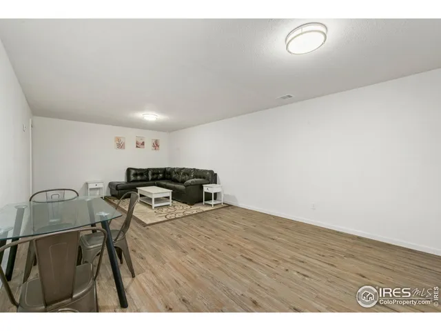 a view of a room with furniture and wooden floor