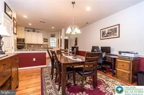 a view of a dining room with furniture and chandelier