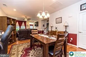 a view of a dining room with furniture and a chandelier