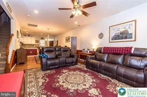 a living room with furniture or couch and a rug