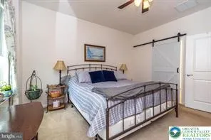 a bedroom with bed and a chandelier