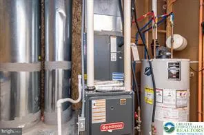 a view of a house with chairs and a table in a patio