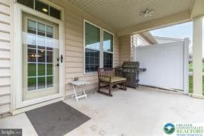 a balcony with chairs and a window