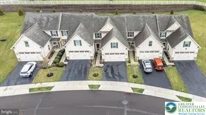 a picture of a building with a couple of cars parked in front of it