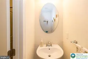 a bathroom with a sink and mirror