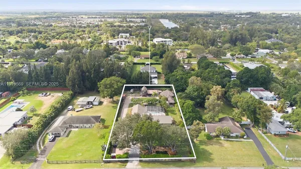 an aerial view of a residential houses with outdoor space