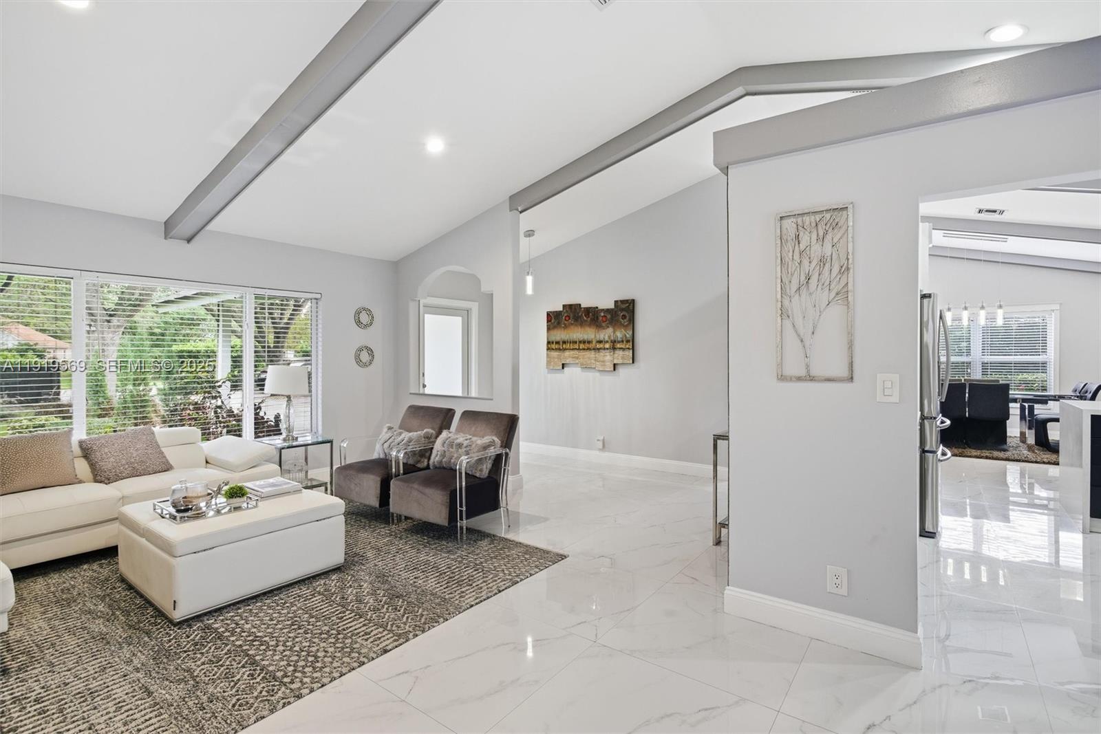 5601 Southwest 195th Terrace Southwest Ranches, FL 33332 - Photo 13 of 84 a living room with furniture and a large window