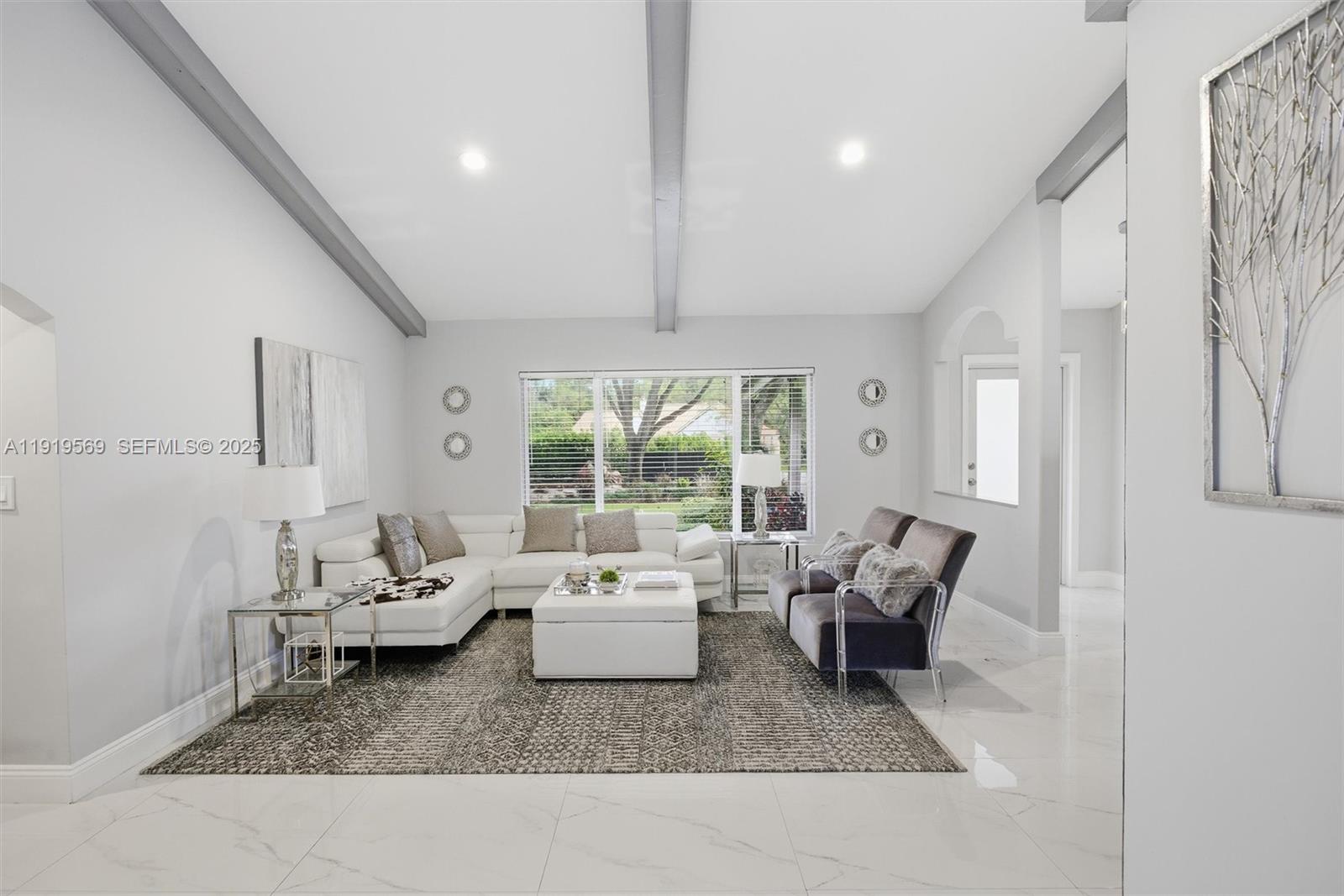 5601 Southwest 195th Terrace Southwest Ranches, FL 33332 - Photo 14 of 84 a living room with furniture and a large window