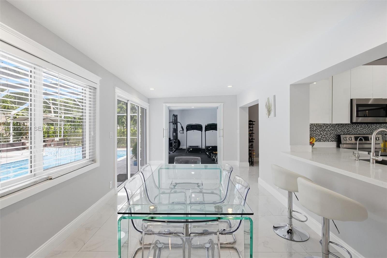 5601 Southwest 195th Terrace Southwest Ranches, FL 33332 - Photo 24 of 84 a living room with fireplace furniture and a large window