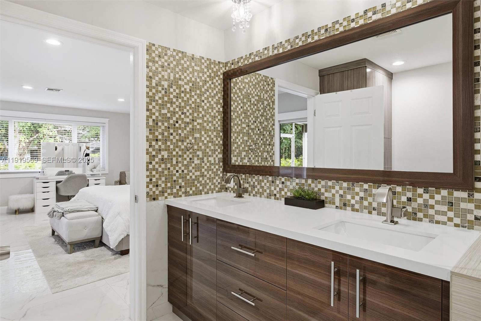 5601 Southwest 195th Terrace Southwest Ranches, FL 33332 - Photo 32 of 84 a bathroom with a double vanity sink and a mirror