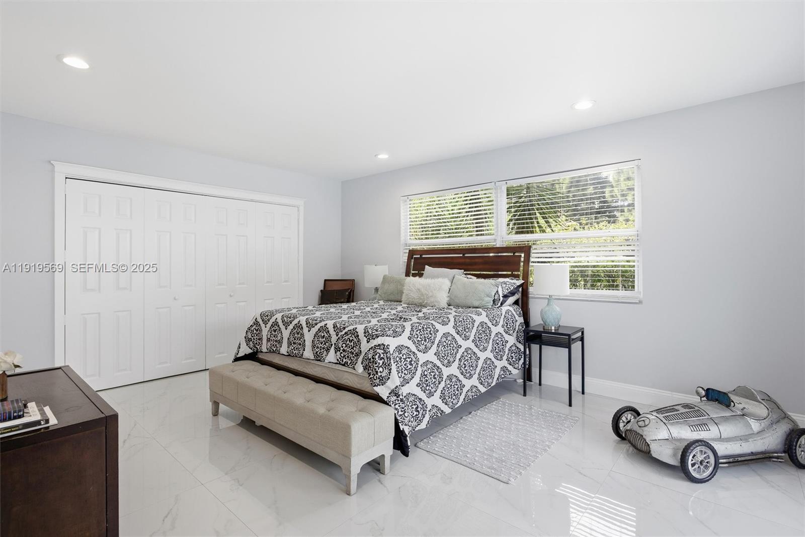 5601 Southwest 195th Terrace Southwest Ranches, FL 33332 - Photo 34 of 84 a bedroom with a bed and a window