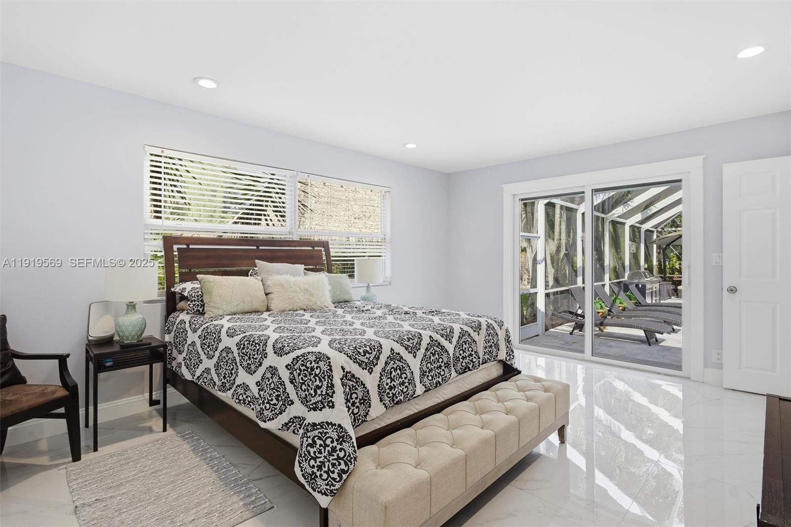 5601 Southwest 195th Terrace Southwest Ranches, FL 33332 - Photo 35 of 84 a bedroom with a bed and a large window