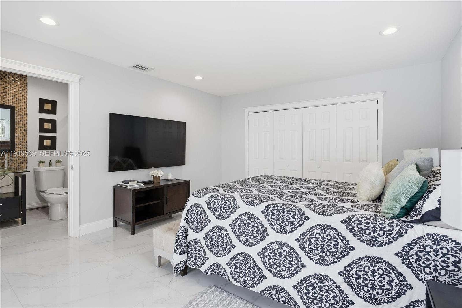 5601 Southwest 195th Terrace Southwest Ranches, FL 33332 - Photo 36 of 84 a bedroom with a bed and a flat screen tv