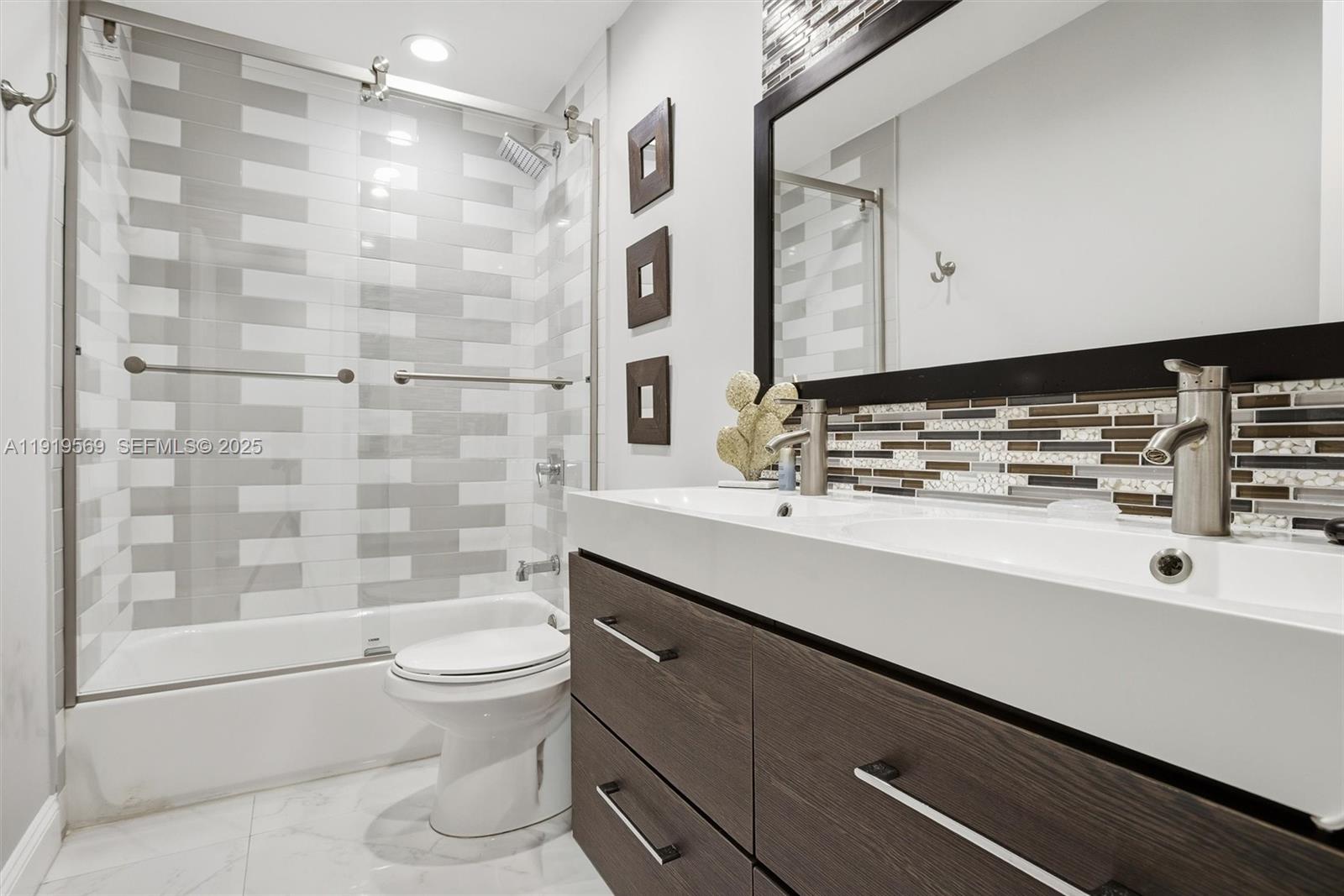 5601 Southwest 195th Terrace Southwest Ranches, FL 33332 - Photo 38 of 84 a bathroom with a sink a toilet and shower