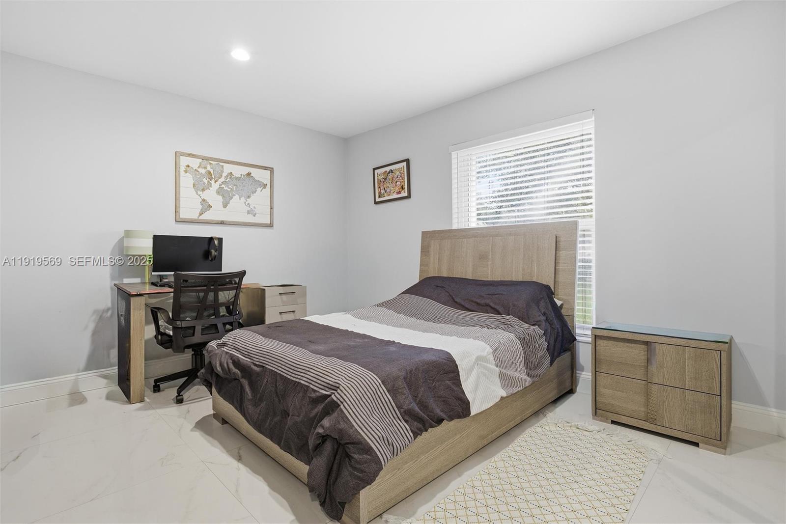 5601 Southwest 195th Terrace Southwest Ranches, FL 33332 - Photo 40 of 84 a bedroom with a bed table chair and a window