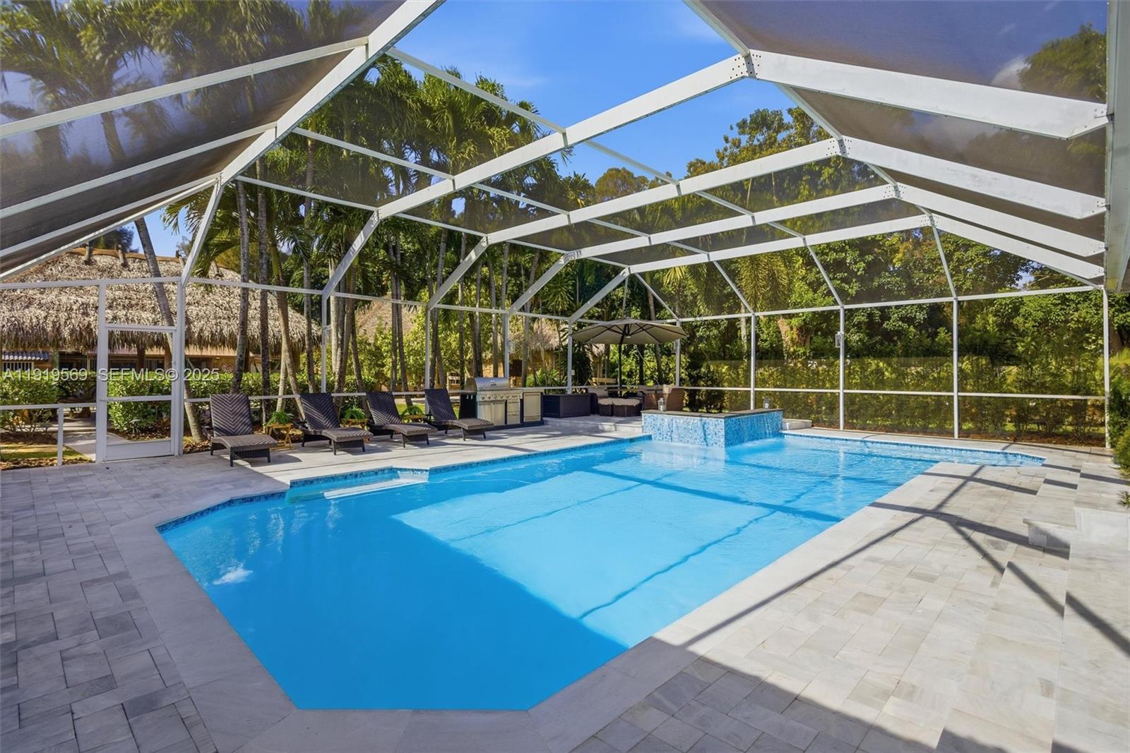 5601 Southwest 195th Terrace Southwest Ranches, FL 33332 - Photo 5 of 84 a view of a swimming pool with a patio