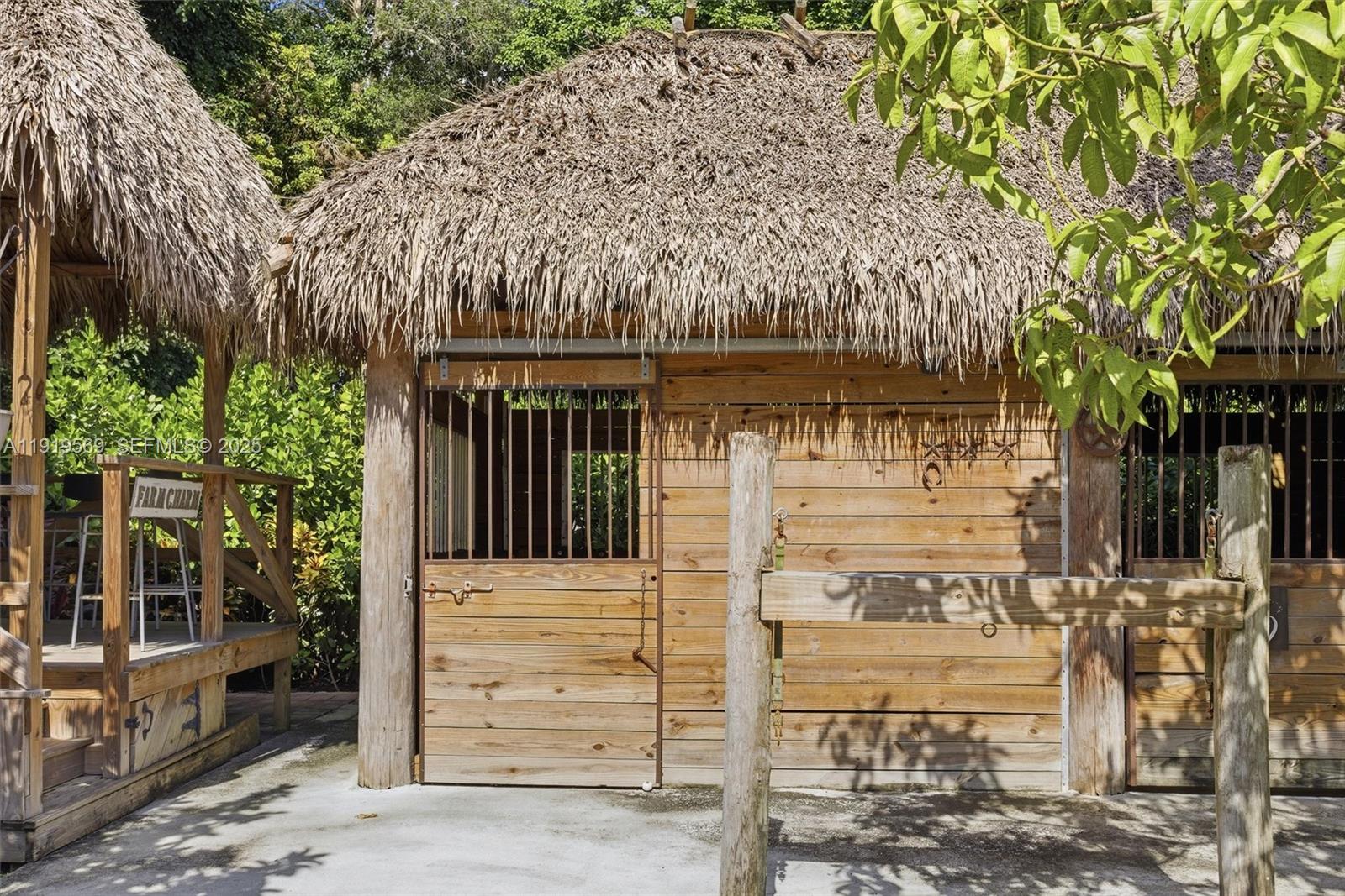 5601 Southwest 195th Terrace Southwest Ranches, FL 33332 - Photo 54 of 84 a front view of a house with a garden