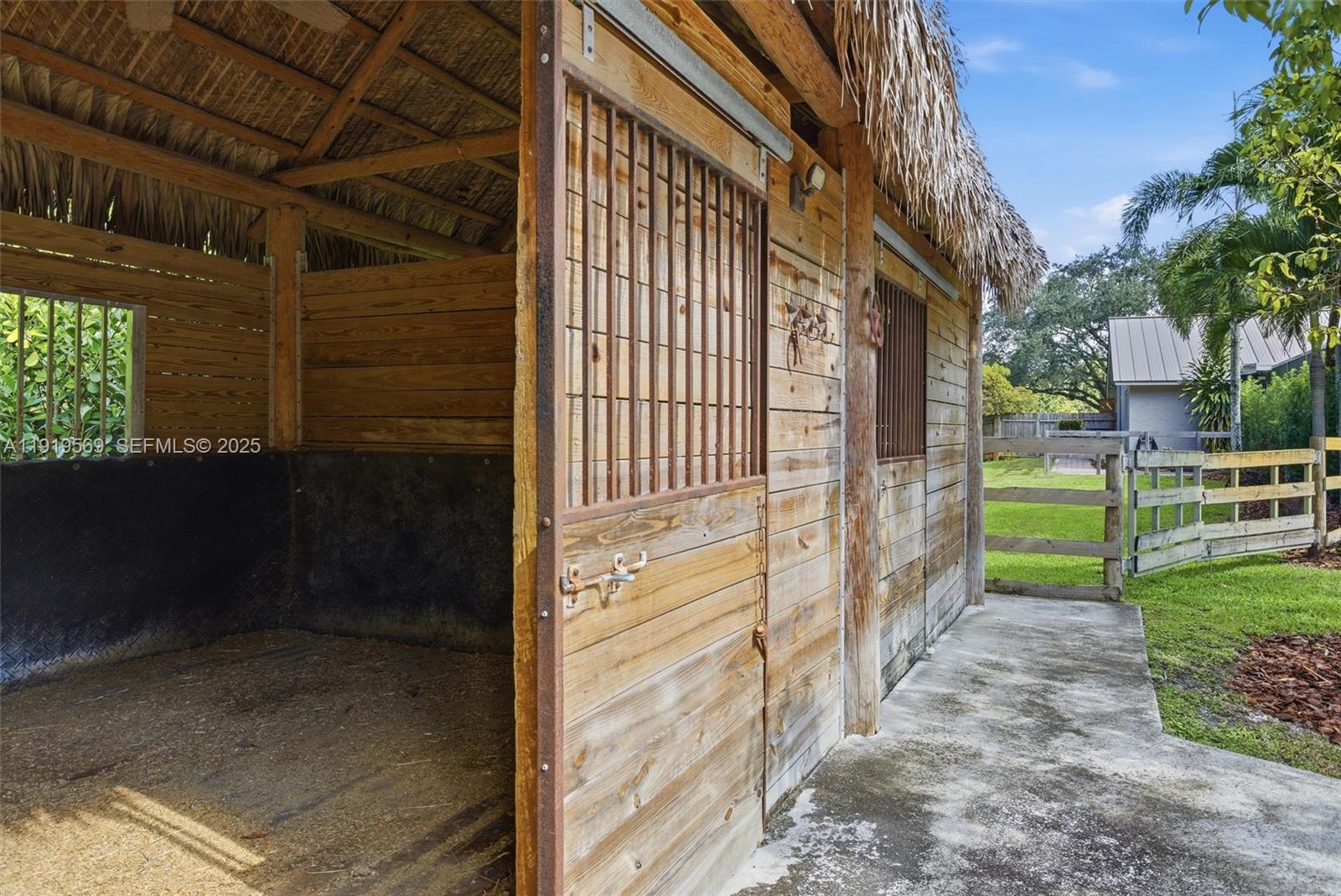 5601 Southwest 195th Terrace Southwest Ranches, FL 33332 - Photo 56 of 84 a view of a pathway of a house with backyard and wooden fence