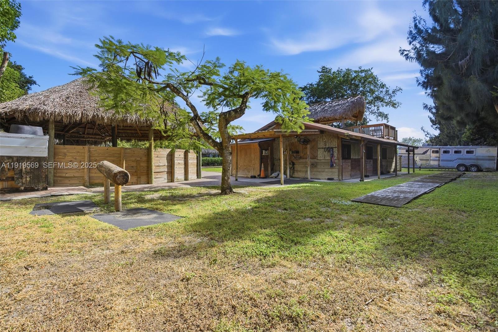5601 Southwest 195th Terrace Southwest Ranches, FL 33332 - Photo 60 of 84 a view of a house with a yard